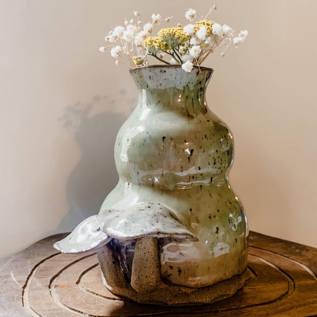 Green ceramic bud vase with sculptural mushrooms on it made by Samm Stafford. Clay mushrooms on pottery 