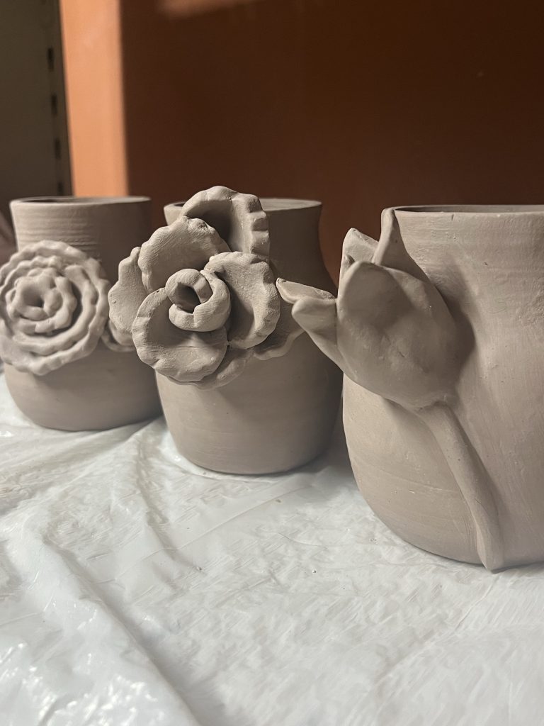 Leather hard stoneware mommy vases drying out before the first kiln firing (bisque firing).​