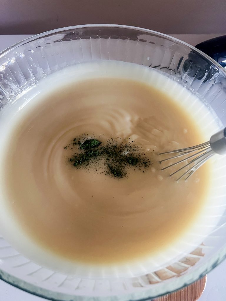 Whisk mixing all natural colorants in cold process soap mixture