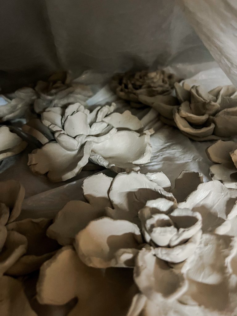 Ceramic flowers drying slowly in plastic bag
