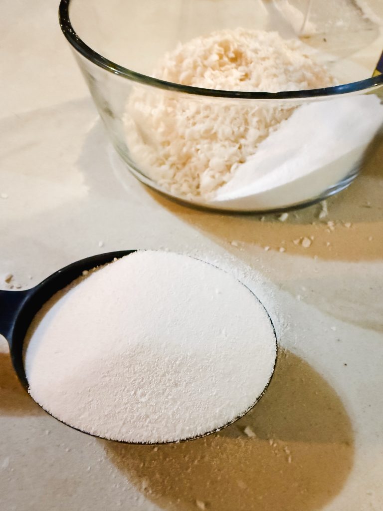Washing soda being mixed in with grated castille soap