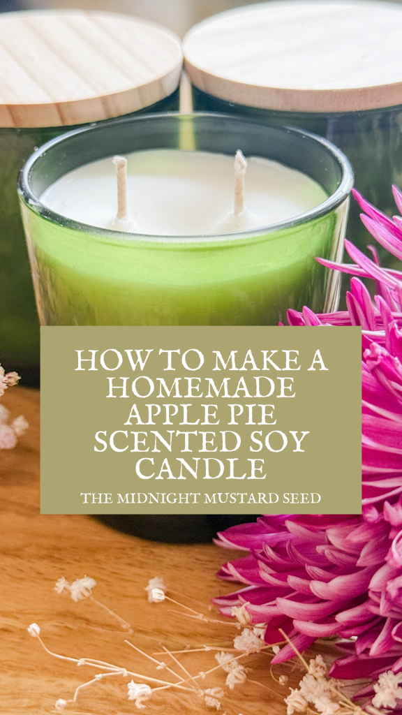 Green glass jar soy candles, purple flowers, and text that says “How to Make Homemade Apple Pie Scented Soy Candle” by the midnight mustard seed